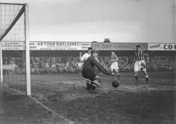 The Blackpool goalkeeper drops on the ball