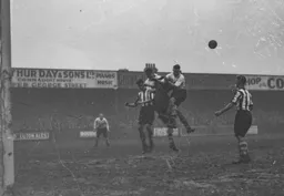 The Exeter goalkeeper punches the ball clear