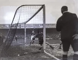 The Cobblers goalkeeper dives in vain to prevent the third goal scored by Roberts
