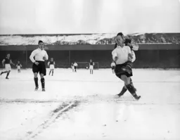 Horace Gager blocks the ball watched by Frank Soo