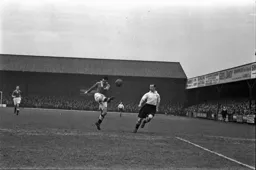 Dally Duncan sees the ball cleared by Roy Paul