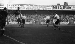 A Bury defender heads clear