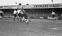 Jack Taylor (centre) on his debut looks to get in on the action