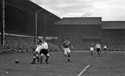 Ron Burgess of Spurs nicks the ball