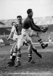 Iorwerth Hughes safely gathers the ball assisted by Billy Cooke