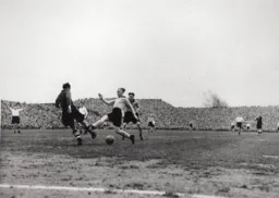 Iorwerth Hughes hacks the ball clear