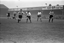 George Stobbart up against Brentford's Jimmy Hill