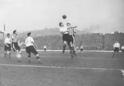 Syd Owen wins this heading duel with Owls striker Derek Dooley