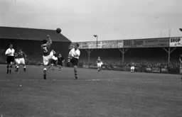 Jesse Pye competes for the ball with Roy Martin