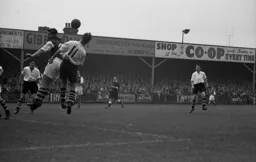 Roy Davies tries to head the ball back to a waiting Gordon Turner