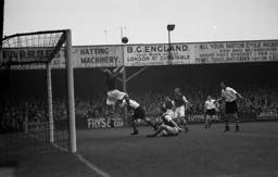 Rotherham keeper Bolton punches the ball away as Bernard Moore bustles in