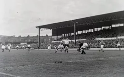 Gwyn Goves gathers the ball as Gordon Turner awaits any possible slip up