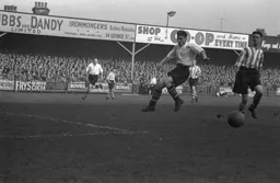 The ball eludes both defender and Bert Mitchell