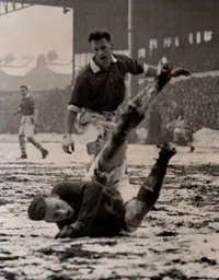 Ron Baynham dives on the ball
