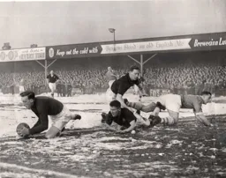 Ron Baynham gathers the ball with Bud Aherne and Syd Owen giving support to thwart Nat Lofthouse