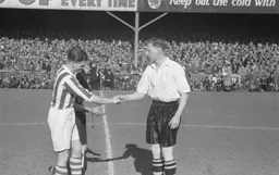 Syd Owen and Huddersfield captain and former Town player Willie Davie shake hands before the kick off