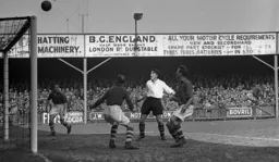 Gordon Turner can only watch as the ball goes over the bar