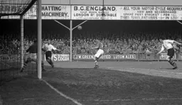 Roy Davies centres the ball towards Gortdon Turner