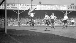 Brentford keeper Reg Newton punches the ball away as Jesse Pye challenges