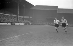 Mike Cullen and Brentford left back Roddie Munro in a race for the ball