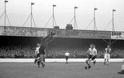 The Oldham keeper clutches the ball with Bernard Moore awaiting an error