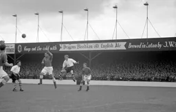 Everton head the ball clear from Arthur Taylor