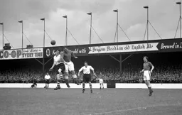 Peter Farrell heads the ball away from George Cummins