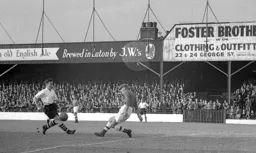 Forest keeper Harry Walker appears to kick the ball away from Johnny Downie