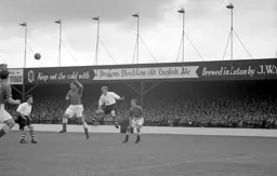 Everton head the ball clear from Arthur Taylor