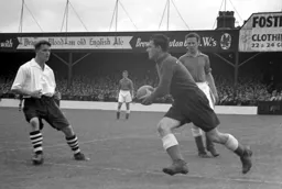 Hugh McJarrow closes in as Harry Leyland gathers the ball