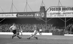 Forest keeper Harry Walker appears to kick the ball away from Johnny Downie