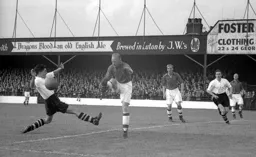 Former Hatter Horace Gager clears the ball away from Gordon Turner