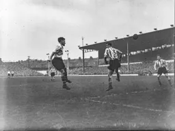 Roy Davies heads the ball across the penalty area