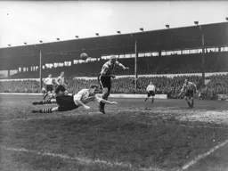 Roy Davies dives full length to try and make contact with the ball