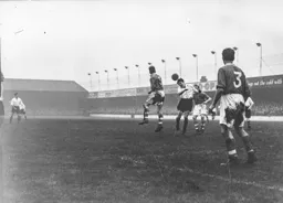 Gordon Turner twists his neck as he heads the ball