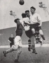 Syd Owen heads the ball away from Hammers John Dick and Tommy Dixon.