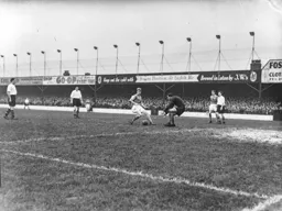 The ball runs through to Ernie Gregory as Bert Mitchell and Gordon Turner watch and wait