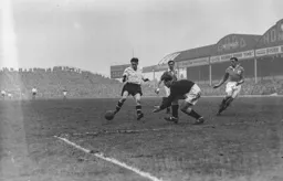 Gordon Turner is beaten to the ball by George Farm