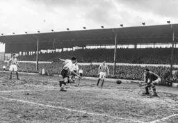 Gordon Turner chases the ball as it goes through to Bill Robertson