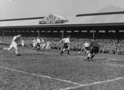 Gordon Turner makes a vain attempt to chase the ball