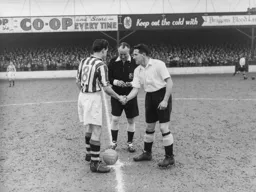 Bud Aherne exchanges pre match pleasantries with former Hatter Jack Taylor watched by referee Mr Burgess