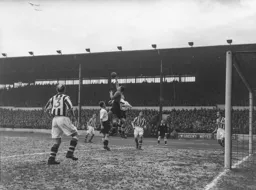 Roy Davies and a leaping Gordon Turner cause Gordon Bradley an anxious moment
