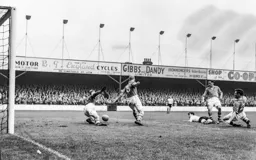 Jimmy Adam goes to ground as Harry Walker and former Hatter Horace Gager apply the block