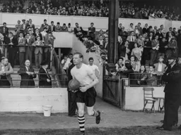 Syd Owen leads the team out onto the field