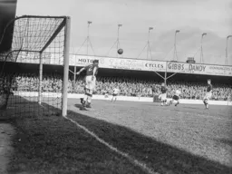 Bert Mozley heads this effort from Gordon Turner off the line