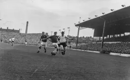 Jimmy Adam tries to force his way past Frank Upton