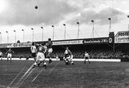A strong header clears the ball for Swansea as Gordon Turner can only watch
