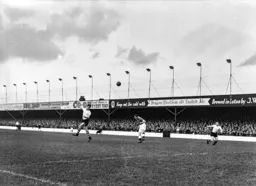 Roy Davies sends a header towards goal