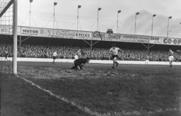 Gordon Turner comes racing in but Charlie Ashcroft has the ball covered