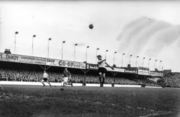 Totally unmarked Roy Davies heads the ball up in the air